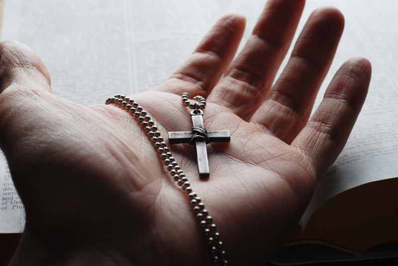 examiner-size-cross-in-hand